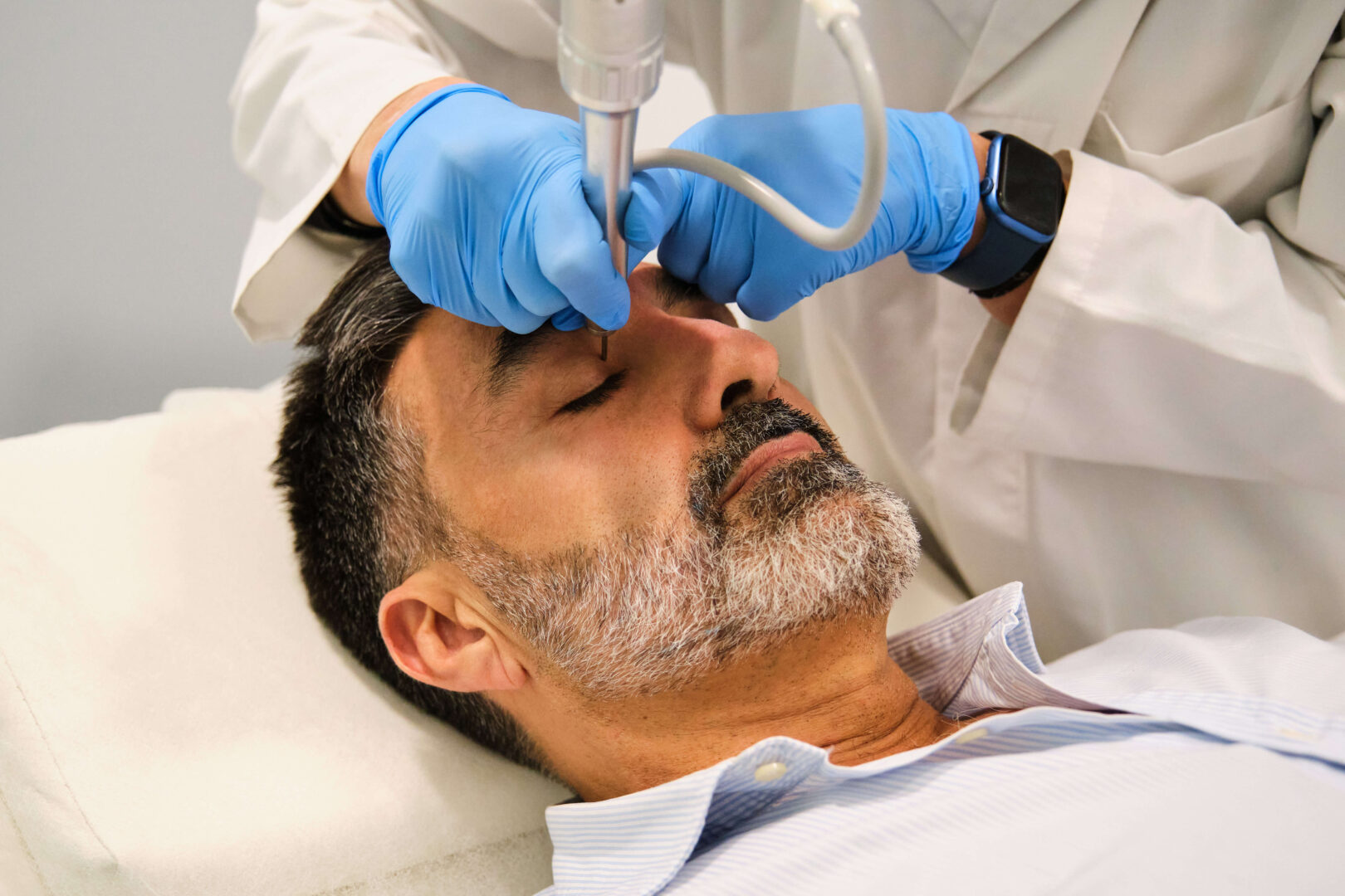 A man is getting a non-surgical eyelid lift.